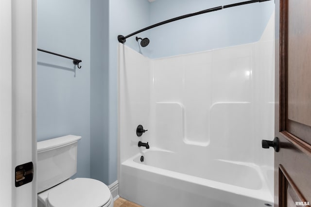 bathroom featuring shower / washtub combination and toilet