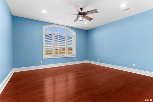 unfurnished room with baseboards, visible vents, a ceiling fan, dark wood-style flooring, and recessed lighting