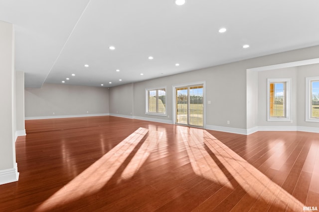 unfurnished living room featuring recessed lighting, baseboards, and wood finished floors