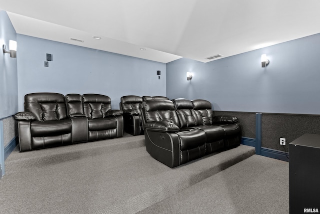 carpeted cinema room with visible vents