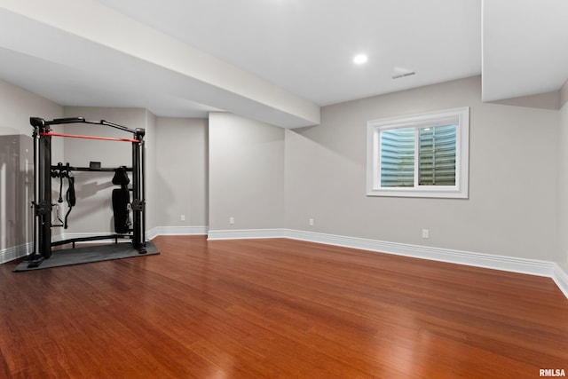 workout area with visible vents, baseboards, wood finished floors, and recessed lighting