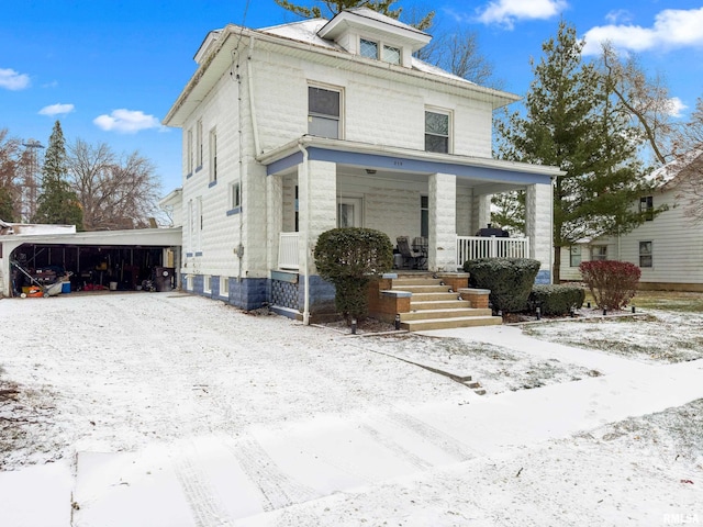 view of front of property featuring covered porch and a garage