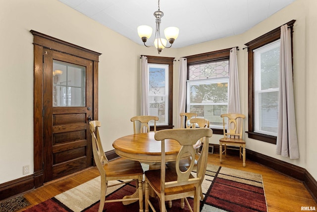 dining room with a chandelier and hardwood / wood-style flooring