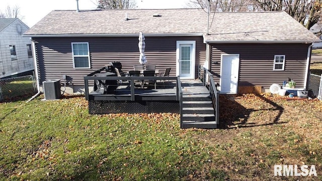 back of house with a lawn, a wooden deck, and central air condition unit