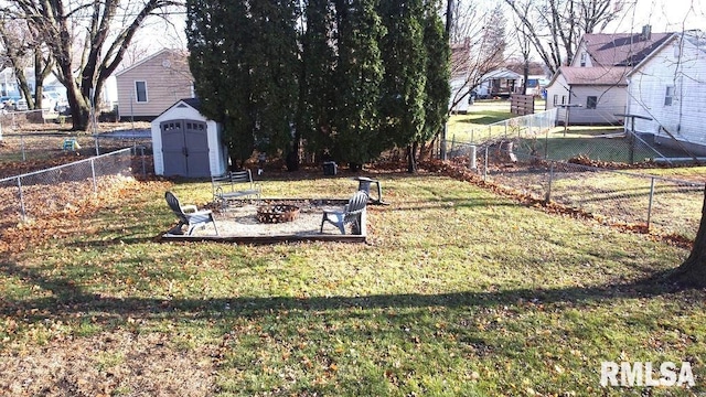 view of yard featuring a fire pit and a storage shed