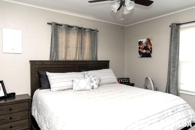 bedroom with multiple windows, ceiling fan, and crown molding