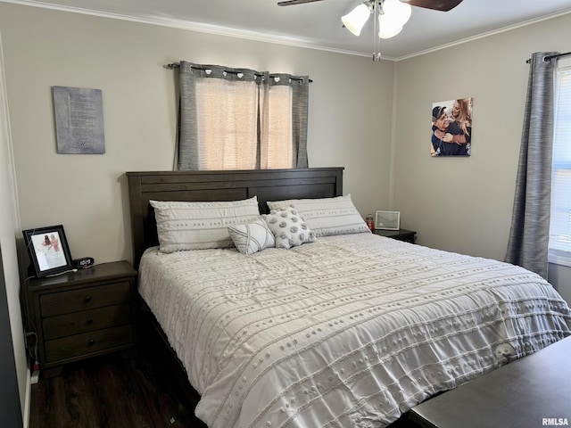 bedroom featuring dark hardwood / wood-style floors, ceiling fan, crown molding, and multiple windows