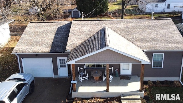 view of front of home with a porch and a garage