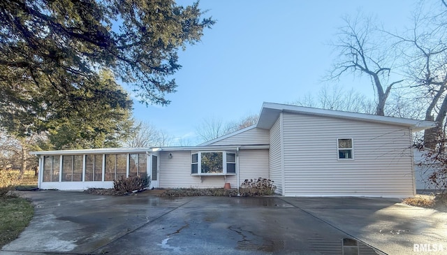 back of property with a sunroom