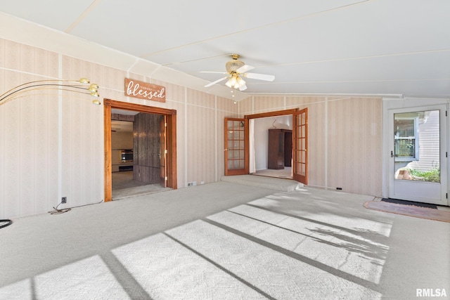 spare room with carpet, ceiling fan, and vaulted ceiling