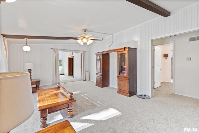 living room with beam ceiling, ceiling fan, and light carpet