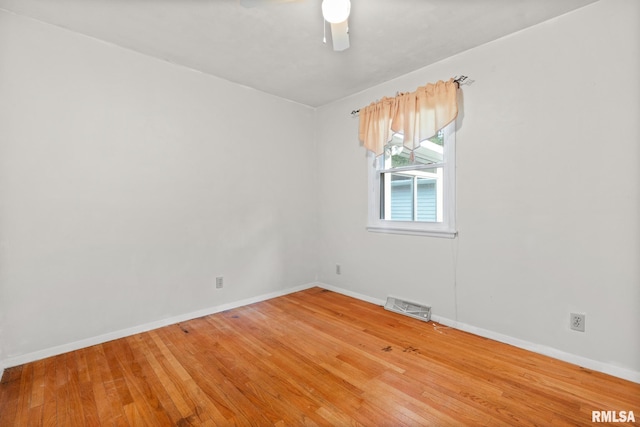 spare room with ceiling fan and wood-type flooring