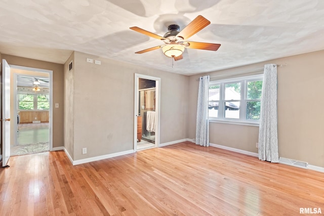 empty room featuring ceiling fan and light hardwood / wood-style floors