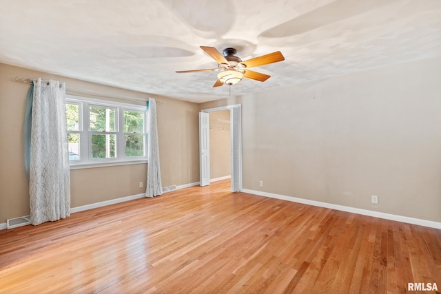 spare room with light hardwood / wood-style floors and ceiling fan