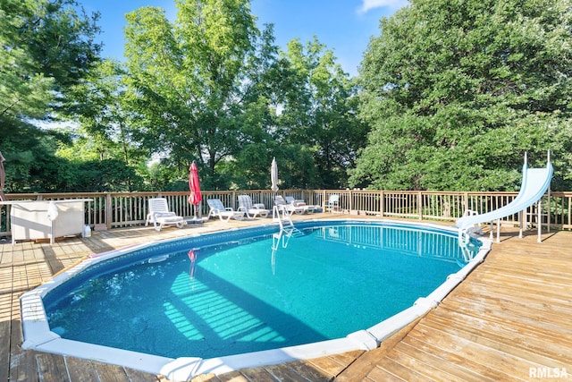 view of pool featuring a deck and a water slide