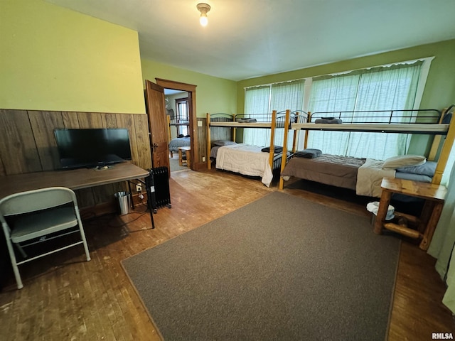 bedroom with dark wood-type flooring and multiple windows