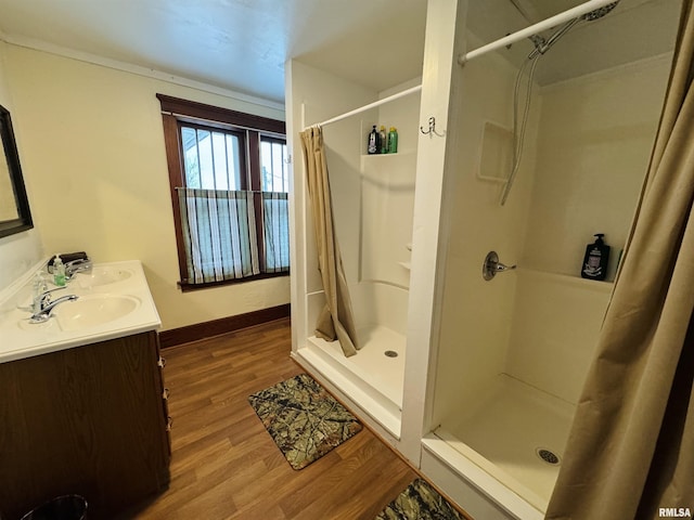 bathroom featuring hardwood / wood-style floors, vanity, and walk in shower