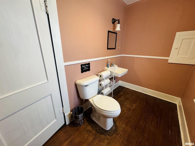 bathroom featuring hardwood / wood-style flooring, toilet, and sink