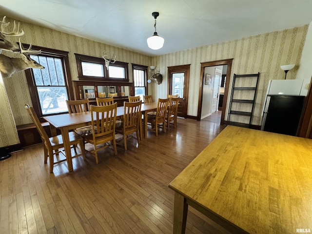 dining space with dark hardwood / wood-style floors