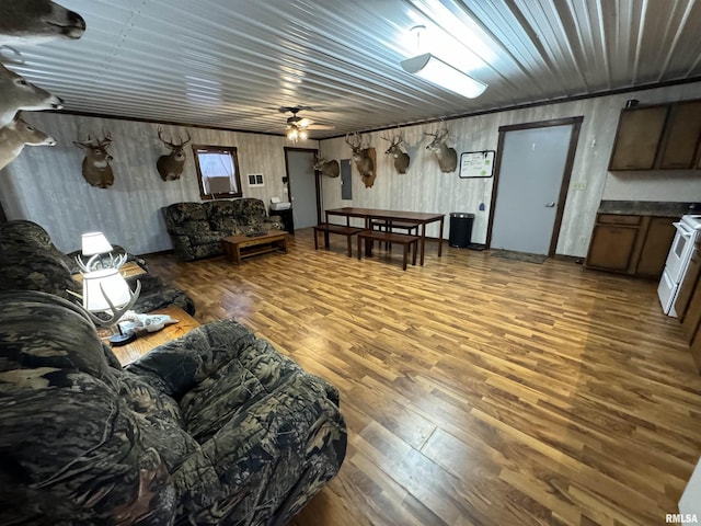 living room featuring ceiling fan and wood-type flooring