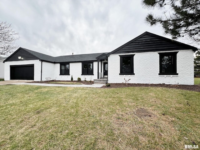 view of front of property with a garage and a front lawn