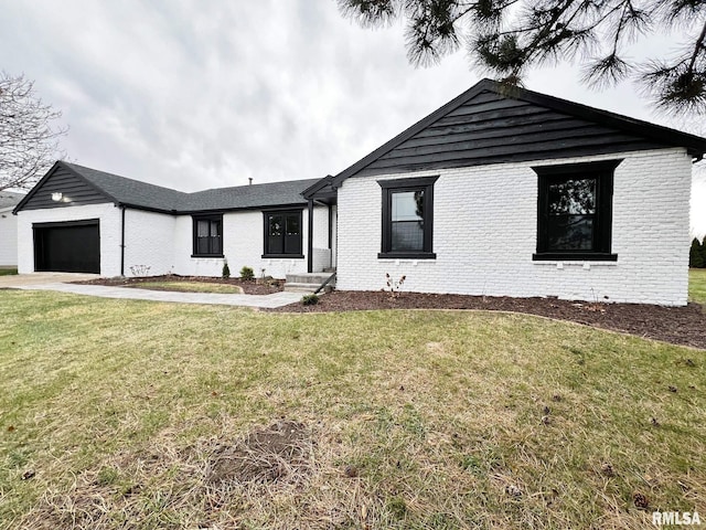 view of front of home with a front yard and a garage