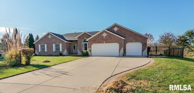 view of front of property featuring a front yard and a garage