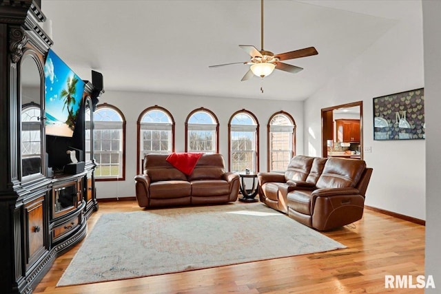 living room with light hardwood / wood-style flooring, ceiling fan, and lofted ceiling