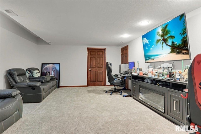 carpeted office space with a textured ceiling