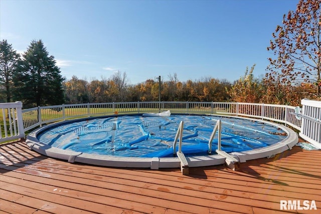 view of swimming pool with a deck