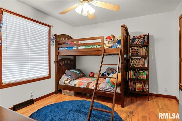 bedroom with light hardwood / wood-style flooring and ceiling fan