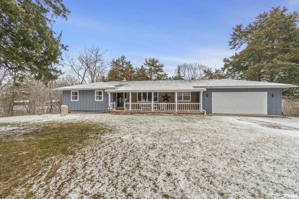 ranch-style house with a garage and a porch