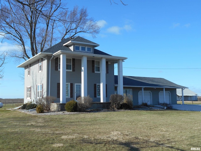 greek revival inspired property with a garage, a front lawn, and aphalt driveway