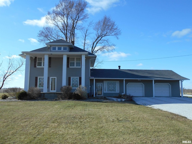 greek revival inspired property with an attached garage, driveway, and a front lawn