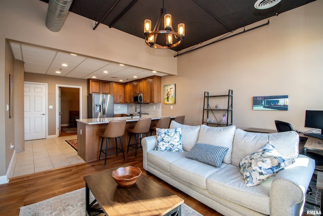 living room featuring light hardwood / wood-style floors and a chandelier