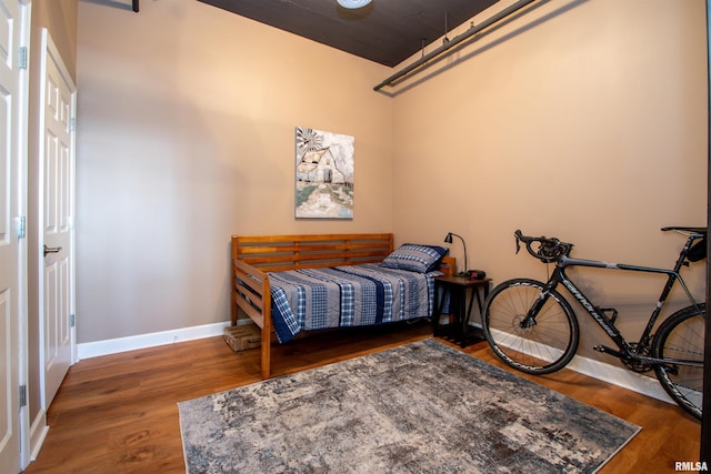 bedroom with dark hardwood / wood-style flooring