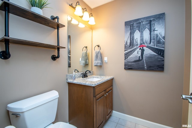 bathroom with tile patterned floors, vanity, and toilet