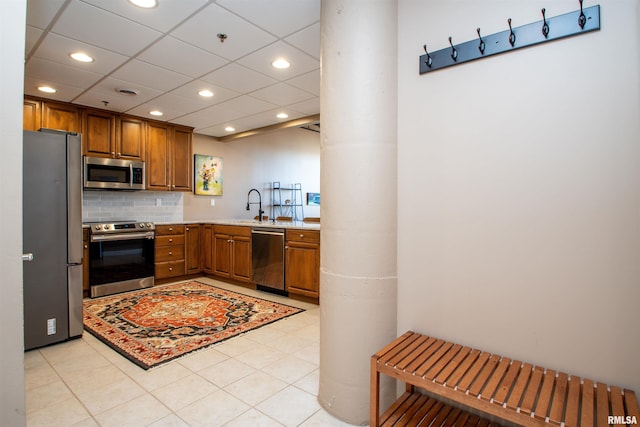 kitchen with sink, stainless steel appliances, and tasteful backsplash