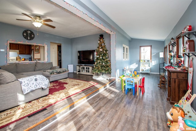 living room with vaulted ceiling, ceiling fan, and dark hardwood / wood-style floors