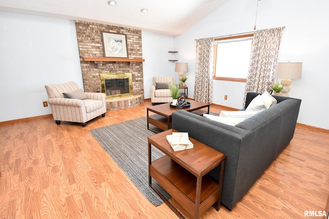 unfurnished living room featuring a brick fireplace, light hardwood / wood-style flooring, ceiling fan, and lofted ceiling