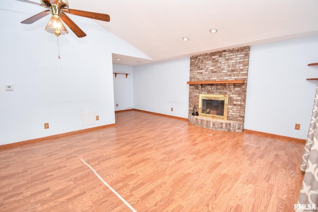 unfurnished living room with ceiling fan, light wood-type flooring, lofted ceiling, and a fireplace