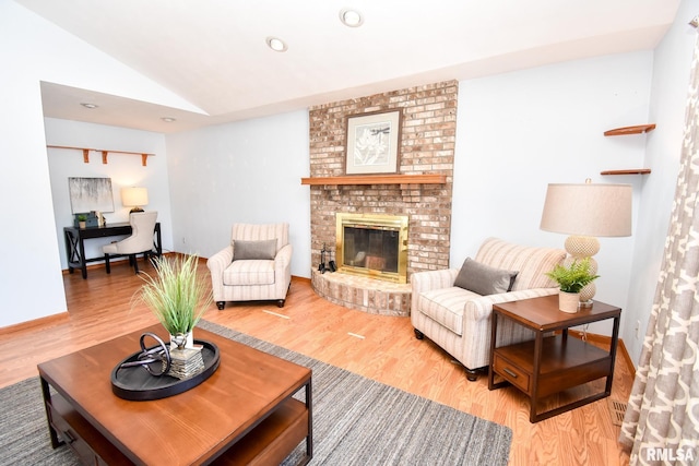 living room featuring baseboards, lofted ceiling, wood finished floors, a fireplace, and recessed lighting