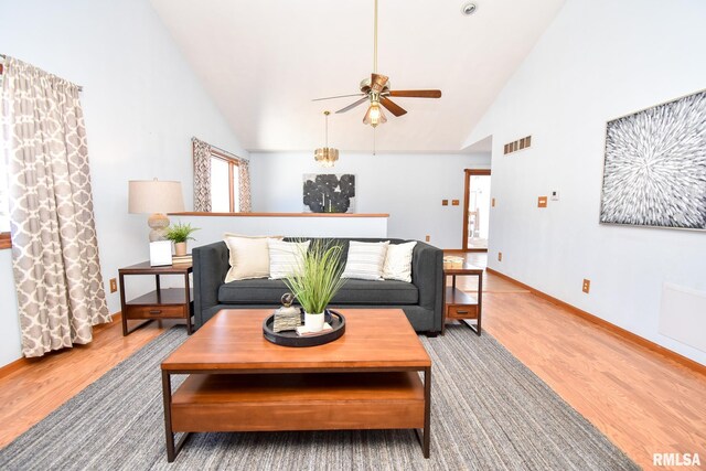 unfurnished living room with light wood-type flooring, high vaulted ceiling, and ceiling fan