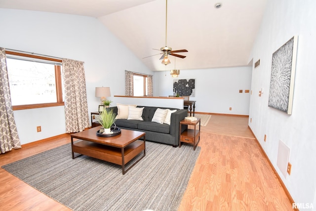 living room with visible vents, high vaulted ceiling, light wood-style flooring, and baseboards