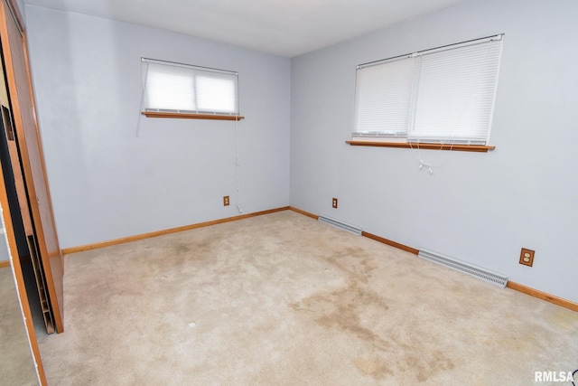 unfurnished room with light colored carpet