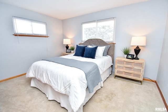 bedroom featuring light carpet and baseboards