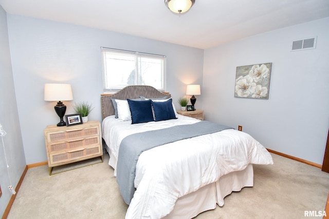 bedroom featuring visible vents, light carpet, and baseboards