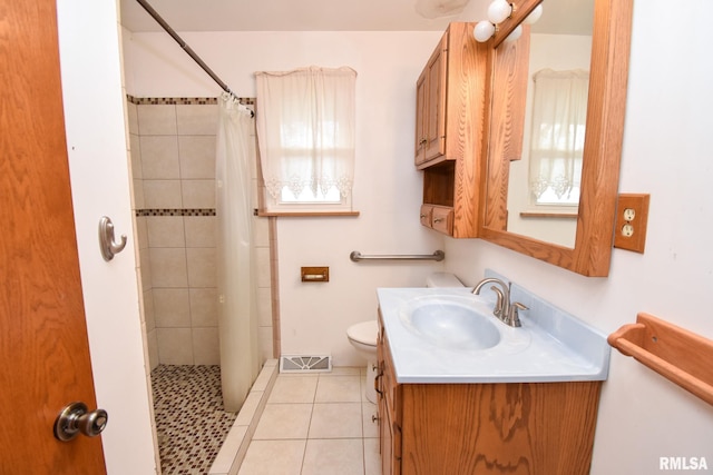 bathroom featuring tile patterned flooring, a shower with curtain, vanity, and toilet