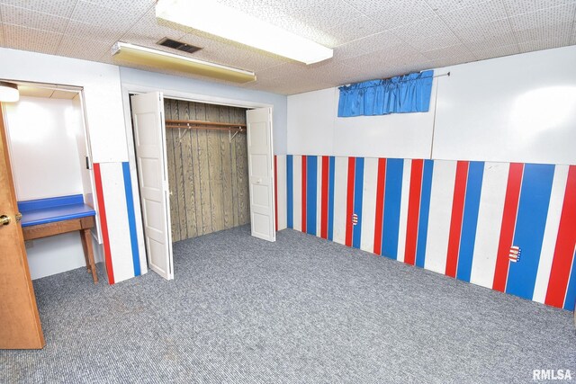 basement featuring dark colored carpet