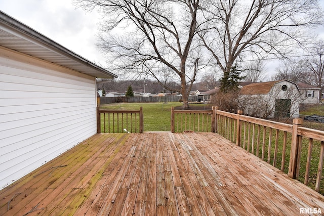 deck featuring a residential view, a yard, an outbuilding, and a storage shed